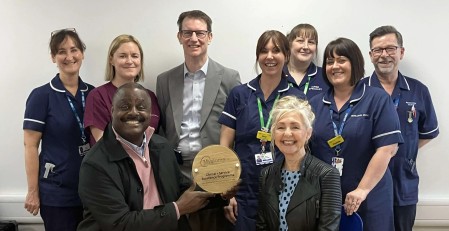 Mel_Tottoh_with_group__plaque_500.jpg