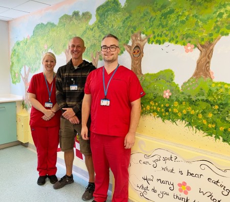 Becky Jason and Matt at MRI wall art area.jpg